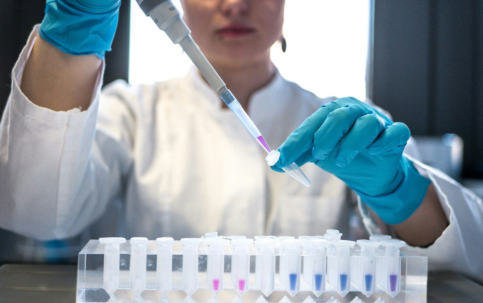A researcher preparing lab samples for genomic analysis
